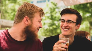 two men smiling with alcohol